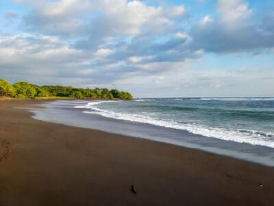 Waves breaking on the dark sand beach at Marbella, Costa Rica