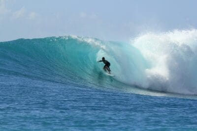 Surfer riding a barrelling wave at Playa Grande