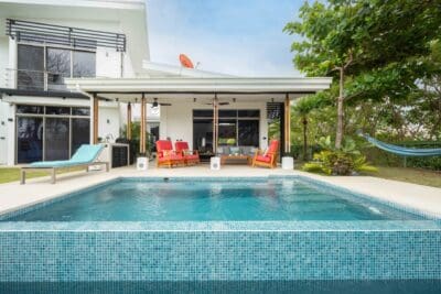 Tiled swimming pool and covered terrace at a modern villa in Marbella
