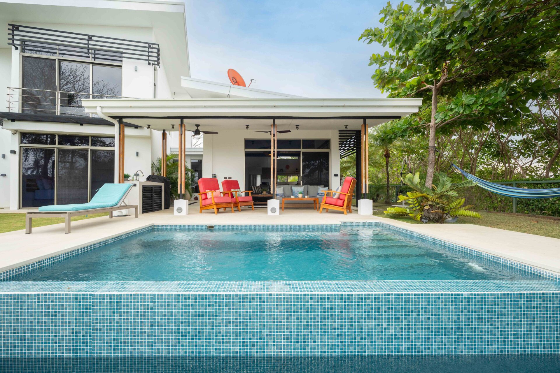 Tiled swimming pool and covered terrace at a modern villa in Marbella