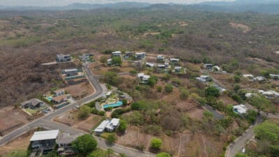 Aerial view of hillside homes and roads in a Marbella neighborhood in the dry season