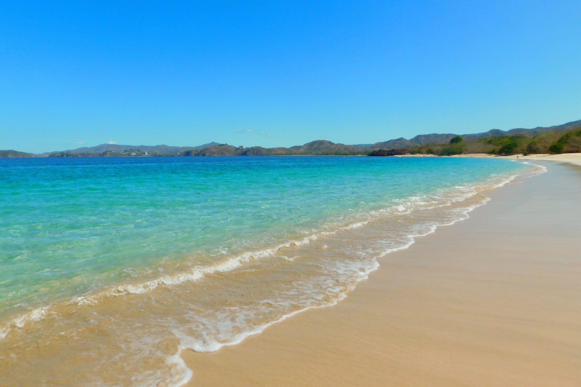 Clear turquoise water of Playa Conchal on a sunny day