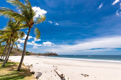 Sunny Costa Rica beach showing the natural beauty and relaxed lifestyle that attracts expat property buyers