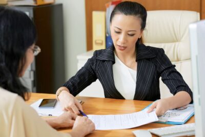 Costa Rican attorney assisting an expat with property transfer documents during the real estate buying process