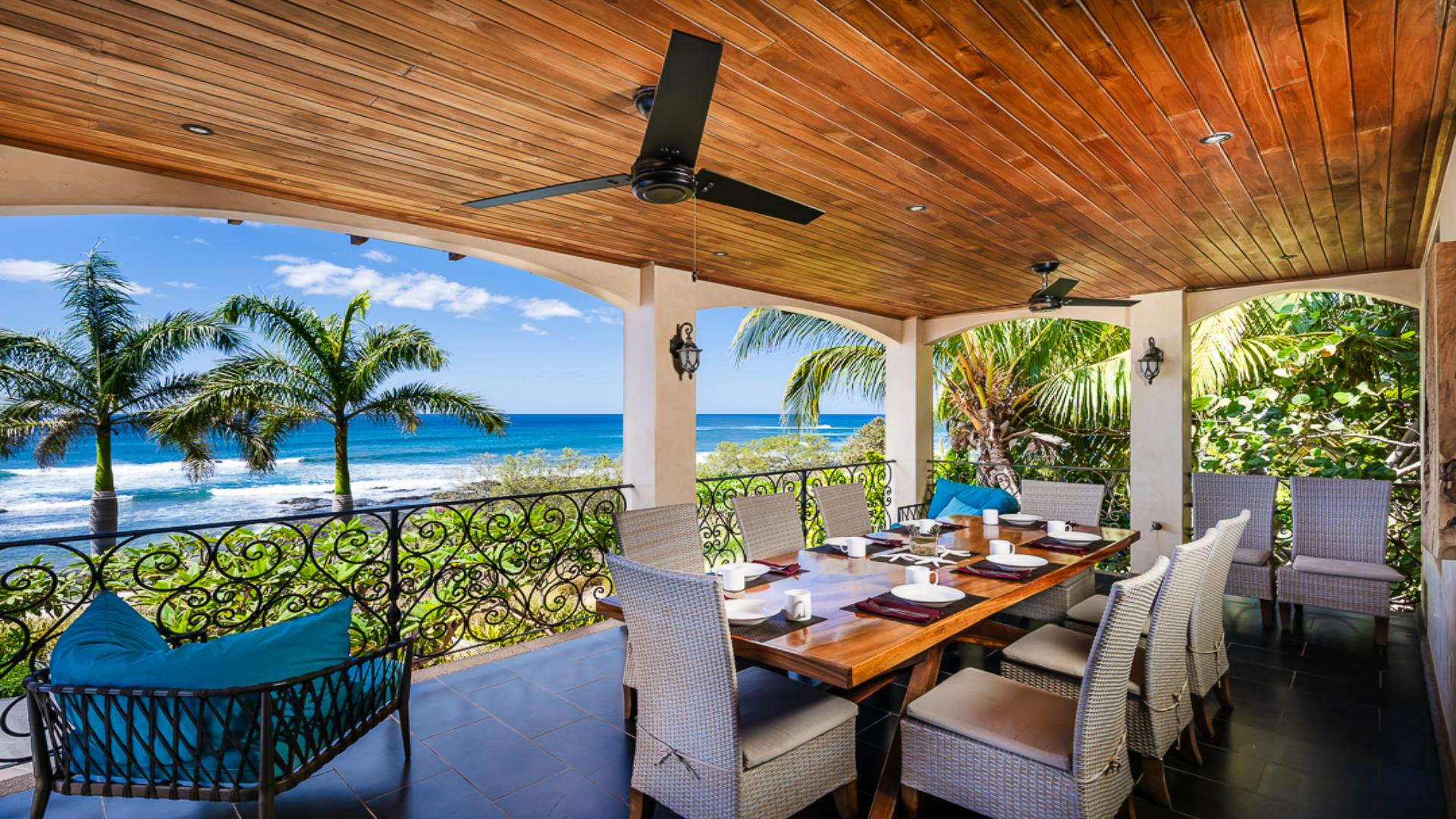 Covered ocean-view terrace with a dining table in Guanacaste